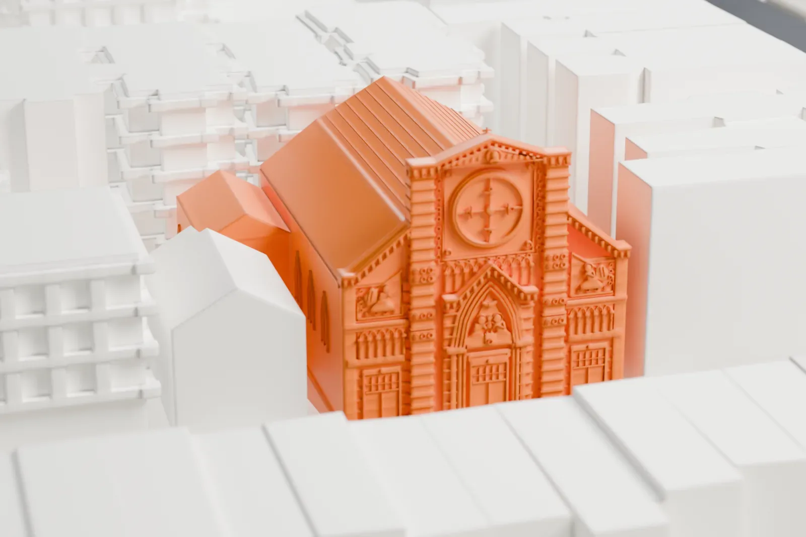 A white 3D print of St. Aloysius Catholic Church, a church with a richly decorated front with a round window and a long pitched roof, set between taller buildings.