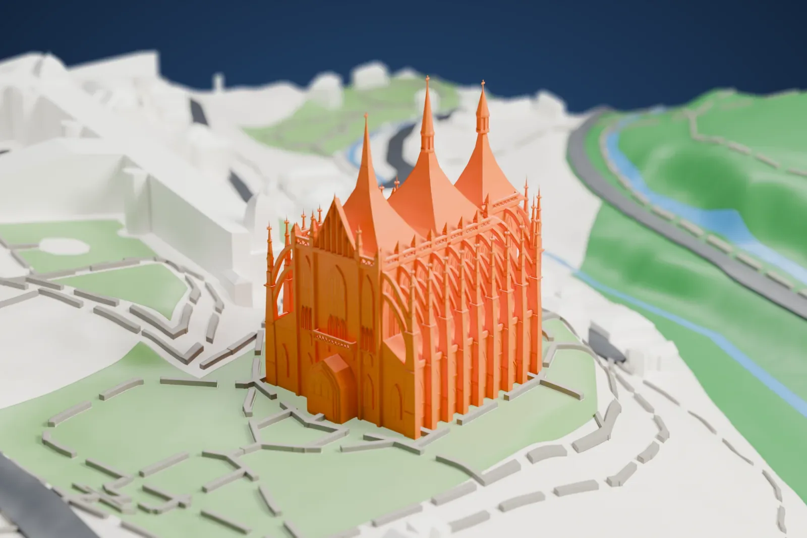 A white 3D print of St. Barbara's Church, a Gothic church with three tall peaked roofs, spires and flying buttresses, standing on a slope among nearby streets and buildings.