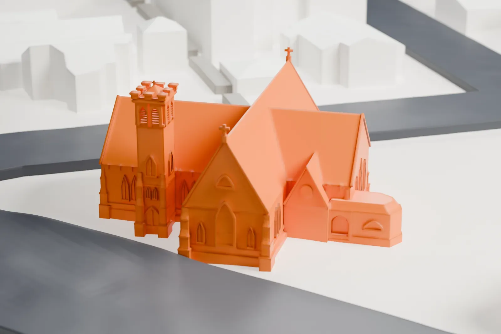 A white 3D print of St. Barnabas' Episcopal Church, a church with steep gabled roofs and a square tower, standing on a triangular lot between roads.