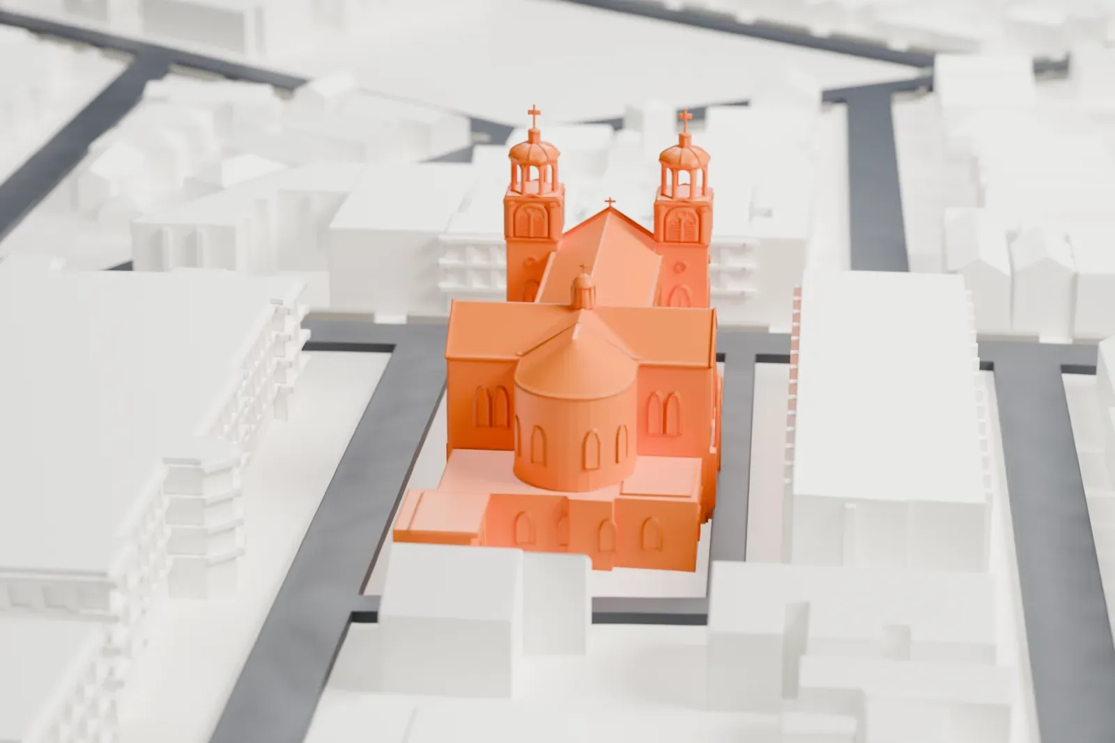 A white 3D print of St. Casimir's Roman Catholic Church, with two domed towers on its front, between taller buildings and streets.