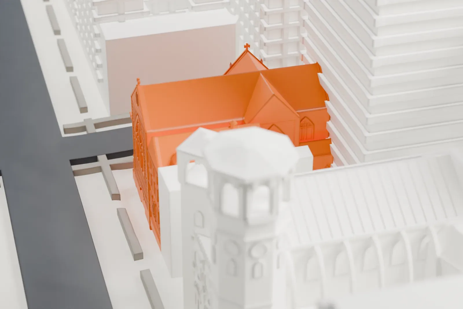 A white 3D print of St. Ignatius of Antioch Church, a small church with a pitched roof squeezed between much taller buildings on a dense city block.