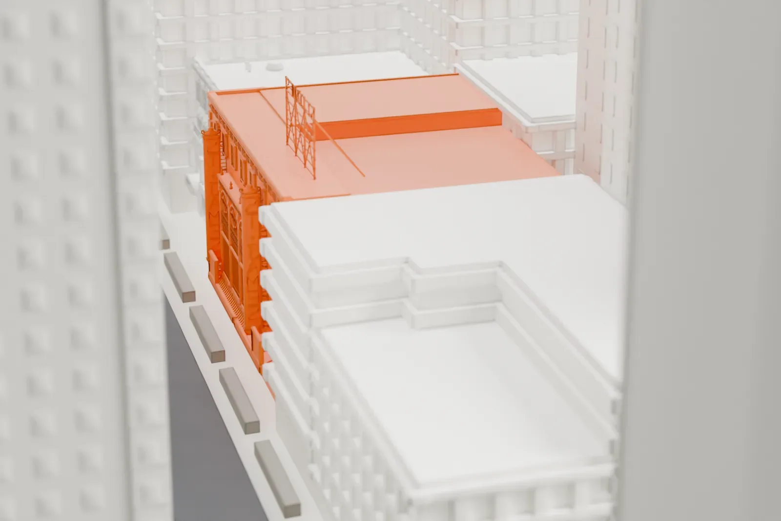 A white 3D print of the St. James Theatre, a low street front at the foot of tall Midtown buildings.