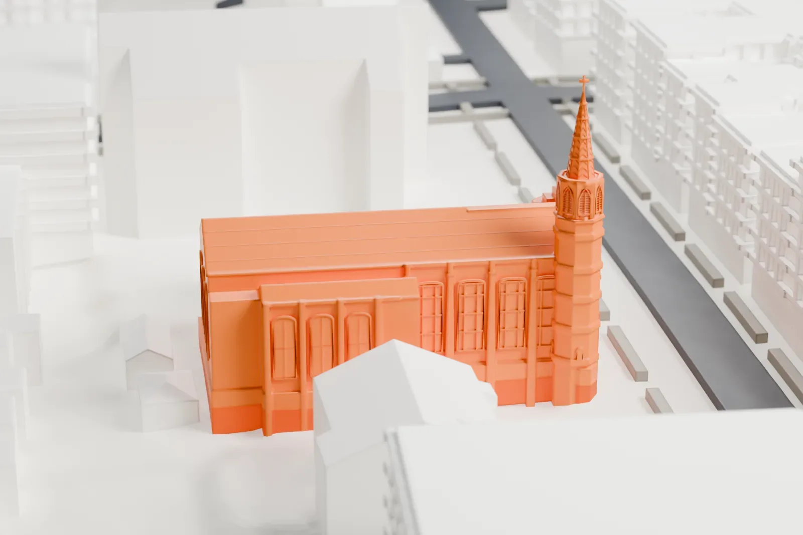 A white 3D print of St. John's Church in the Bronx, a long church with a steep roof and a tall spire at one corner, among taller buildings.