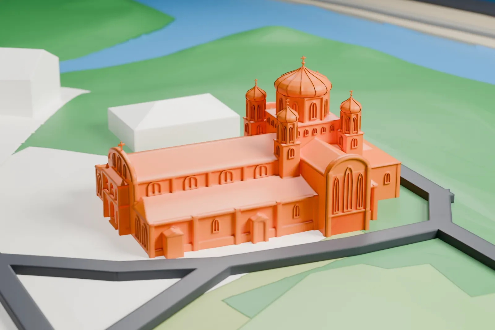 A white 3D print of St. John the Baptist national shrine in Ottawa, shown among the surrounding streets and buildings.