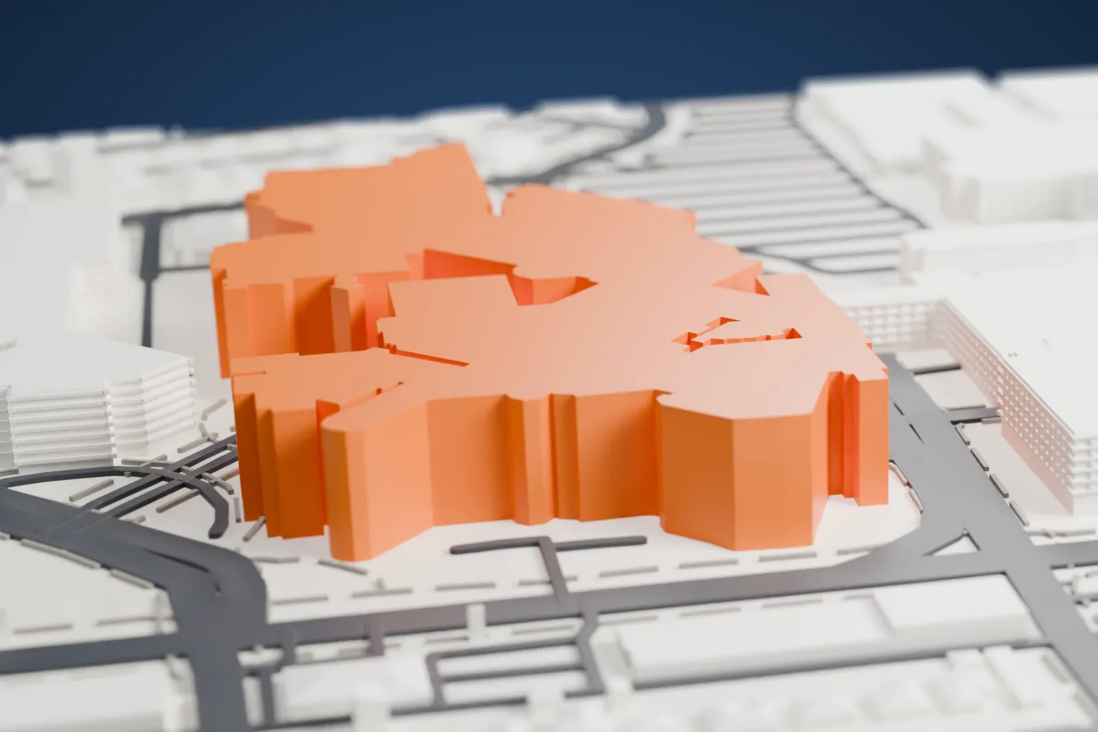 A white 3D print of St. Joseph's Hospital and Medical Center, a cluster of joined wings of different heights surrounded by roads, parking and neighborhood blocks.