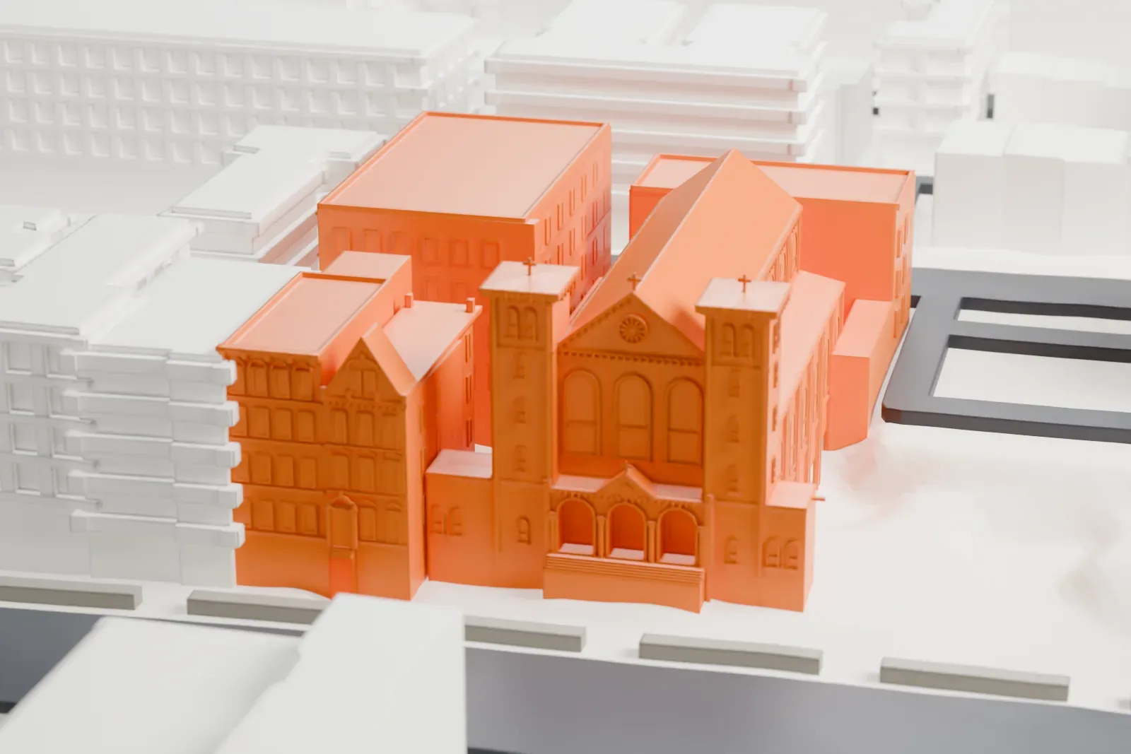 A white 3D print of St. Luke's Church, a long church with small towers and an arched-window nave joined to a taller block, among other buildings with a patch of green nearby.