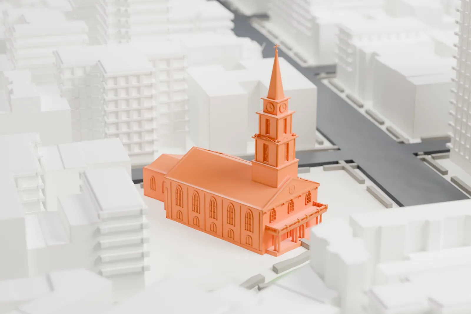 A white 3D print of St. Mark's Church in-the-Bowery, a small church with a steeple standing beside a patch of green, surrounded by dense city blocks.