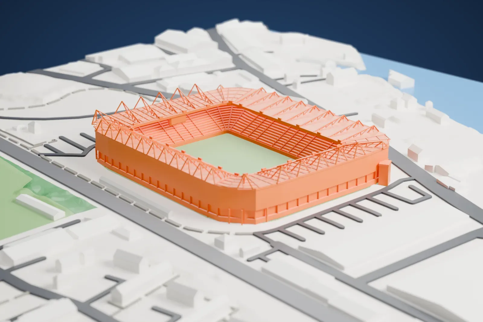 A white 3D print of St Mary's Stadium, a closed bowl of four equal stands under one roof, with a ring of pyramid trusses standing above its back edge, among the streets and buildings around it.