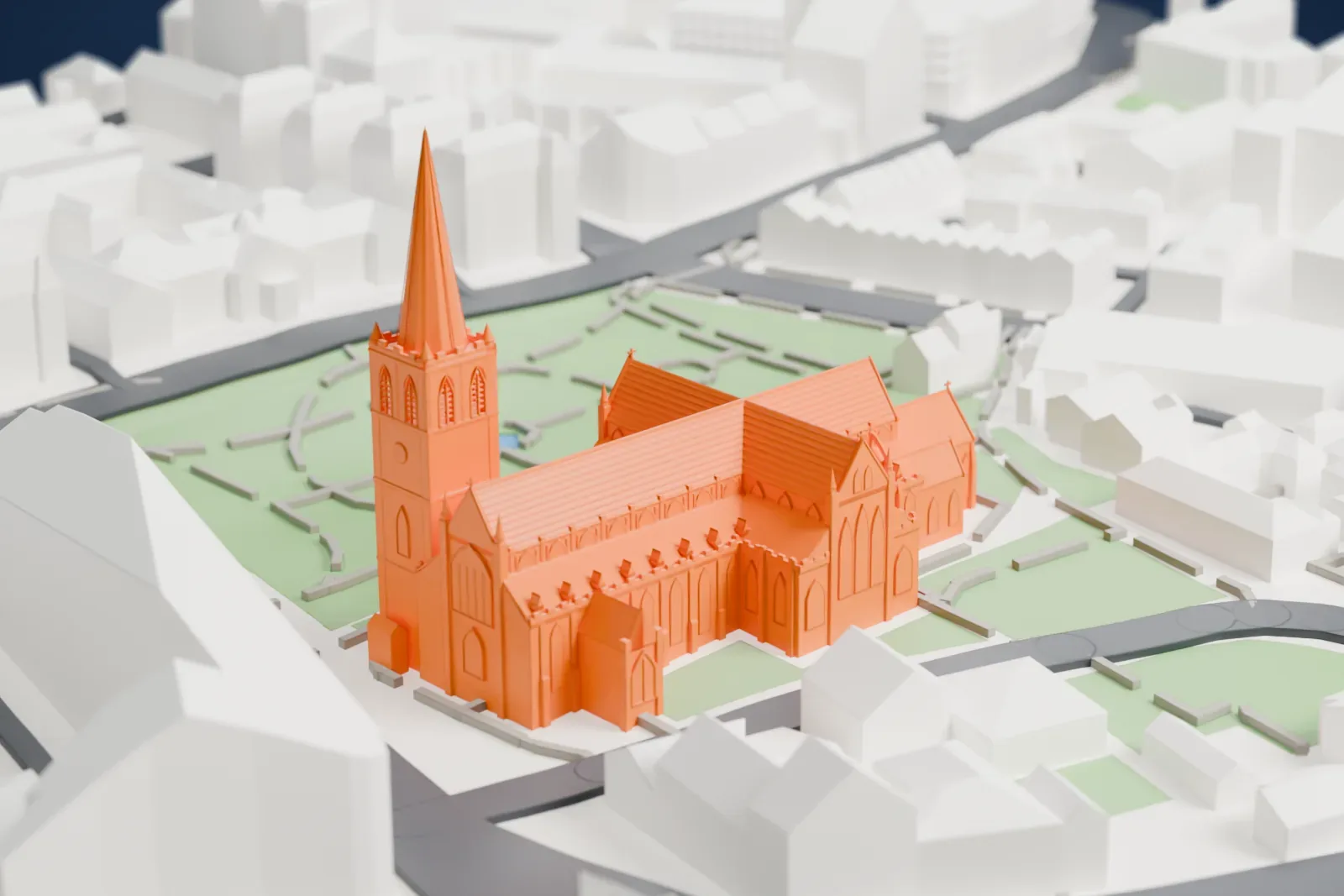 A white 3D print of St Patrick's Cathedral, a long cross-shaped Gothic church with a pointed spire on its tower, beside green space and surrounded by buildings and streets.