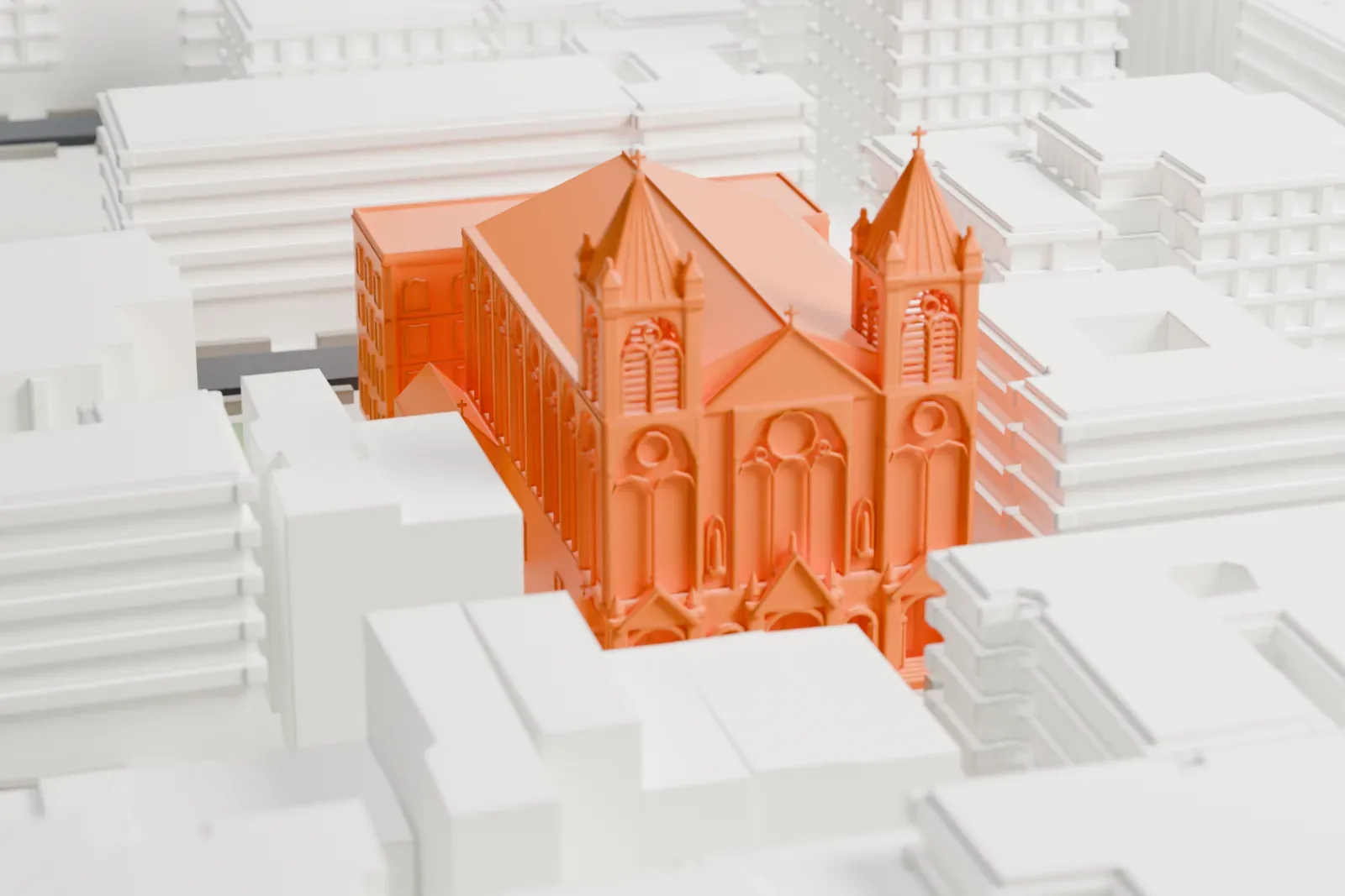 A white 3D print of St. Paul Church, a long church with twin pointed spires at its front and rows of arched windows, among dense city blocks.
