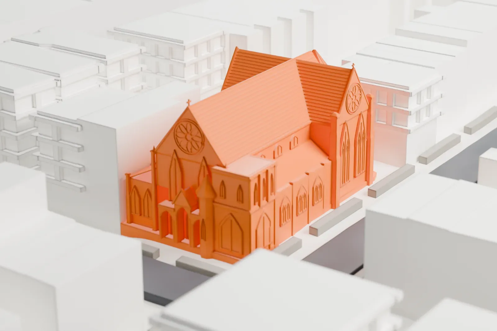 A white 3D print of St. Paul’s Episcopal Church, a steep-roofed church with a round window, among low city buildings and streets.
