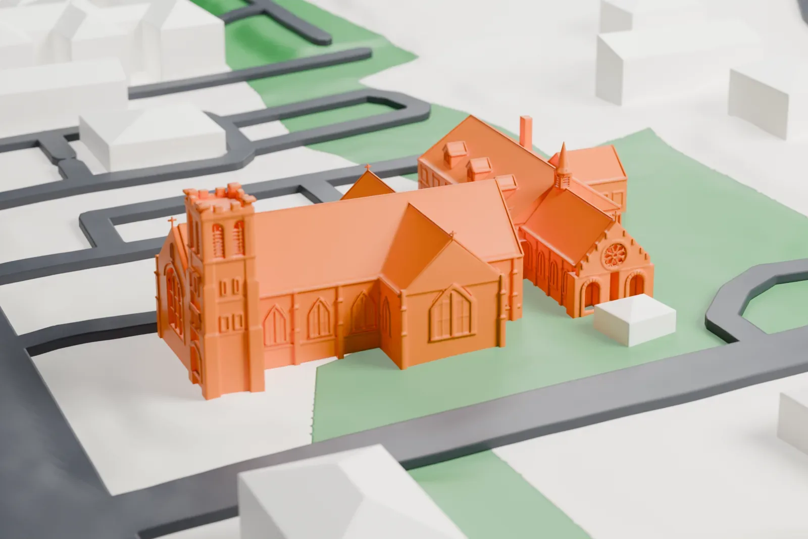 A white 3D print of St. Paul's Episcopal Church, with its square tower and steep gabled roofs, beside green lawns and streets.