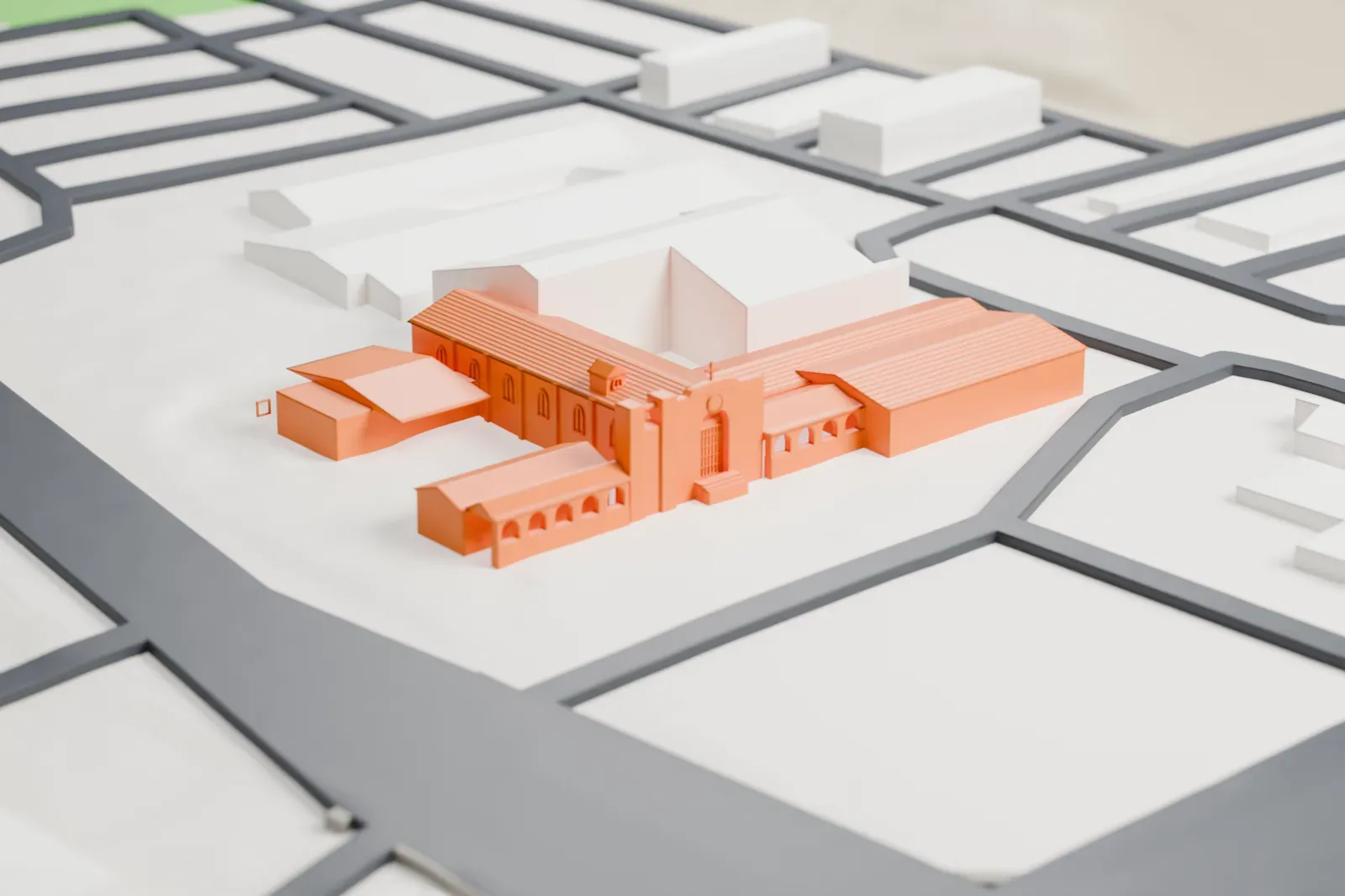 A white 3D print of the St. Philip's in the Hills church, with pitched roofs and arched openings among neighboring buildings and surrounding streets.