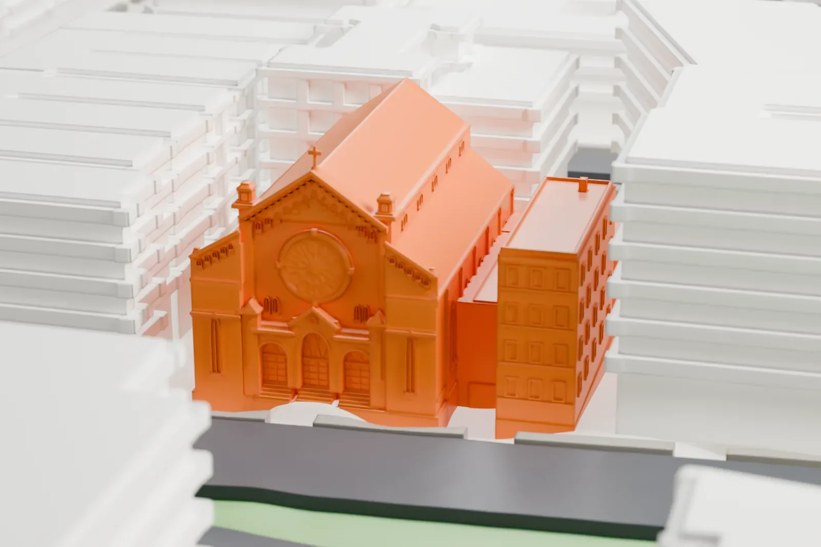 A white 3D print of St. Rose of Lima Church, a long gabled church with an arched front and a rectory beside it, among taller buildings.