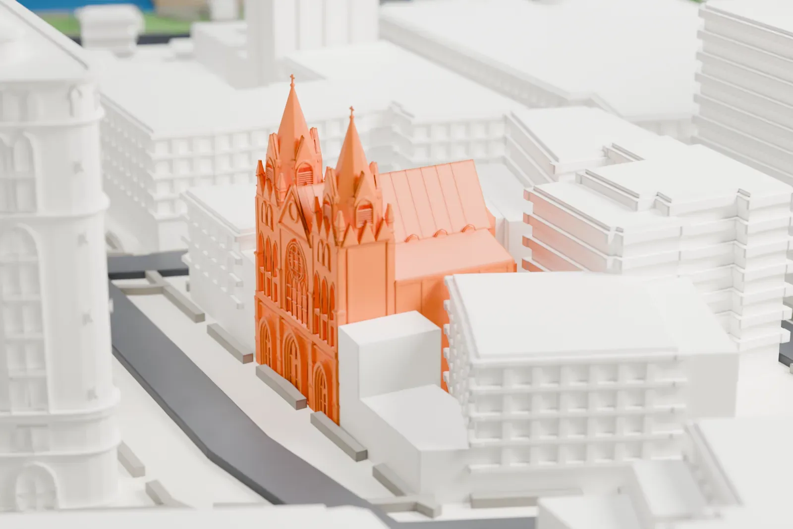 A white 3D print of St. Veronica Church, a Gothic-style church with pointed towers, almost hidden among taller buildings and streets.