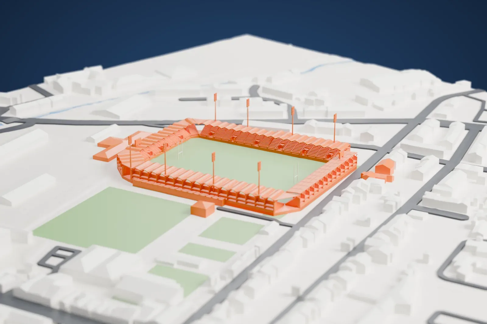 A white 3D print of Stade Aimé Giral, a rugby stadium with scalloped stand roofs and tall floodlight masts around a green pitch, surrounded by dense city blocks.