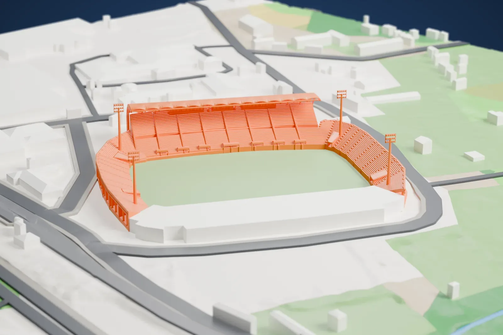 A white 3D print of the Stade Armand-Cesari, with a covered grandstand, low open end terraces, and surrounding city buildings.