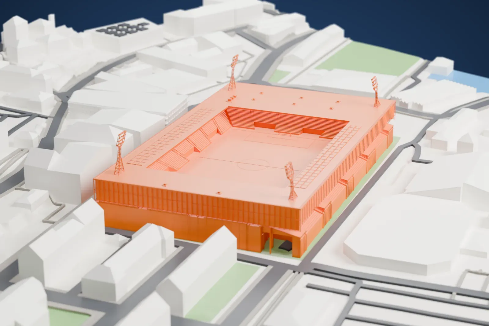 A white 3D print of the Stade de la Maladière, a low rectangular stadium with an open roof over the pitch and four floodlight pylons, among surrounding streets and buildings.