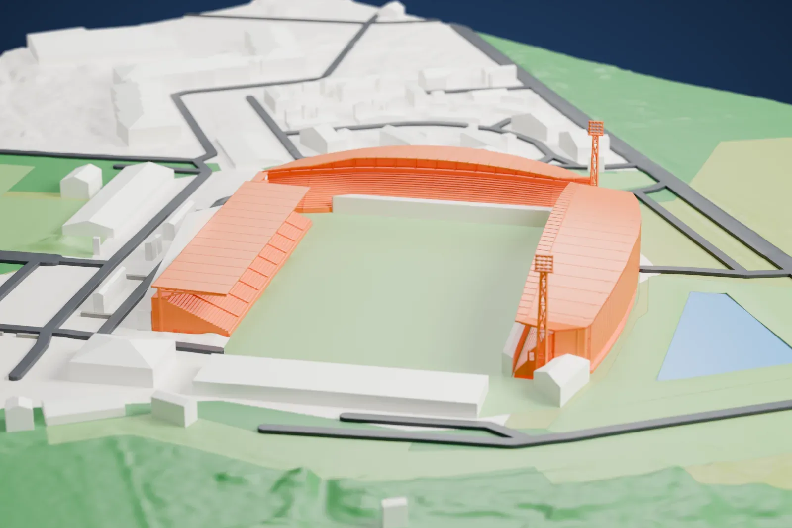 A white 3D print of the Stade du Hameau with roofed stands around an open field and two lattice masts, surrounded by roads, buildings, and green space.