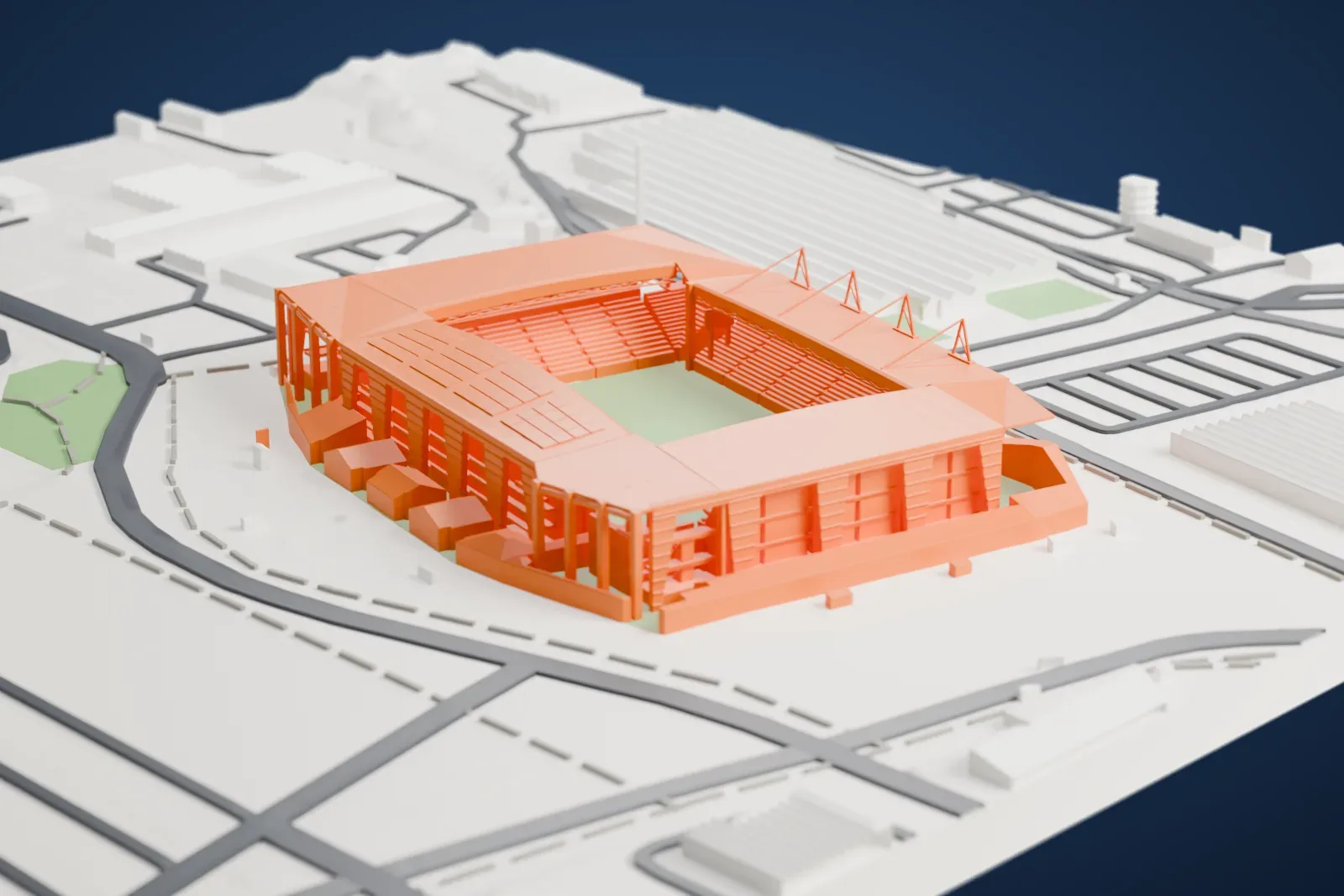 A white 3D print of Stade Geoffroy-Guichard, a roofed four-sided football stadium around a green pitch, set among wide roads and large gray buildings.