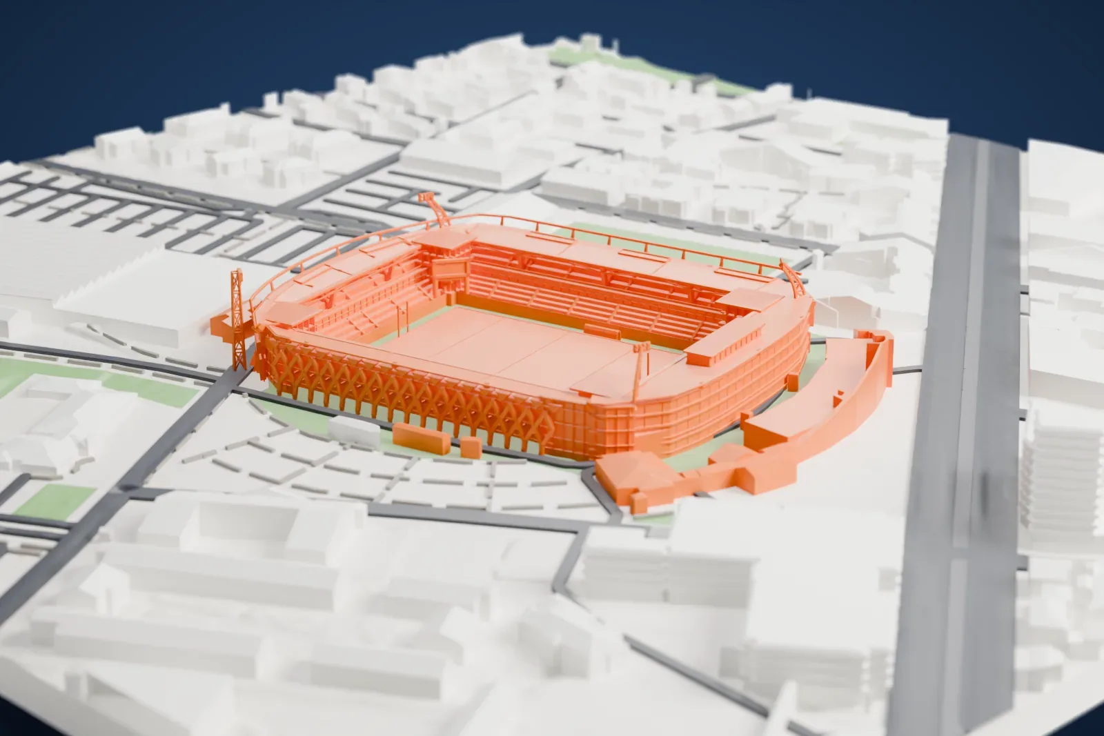 A white 3D print of the Stade Marcel-Michelin, a rectangular stadium with four joined stands, set among streets, green fields and nearby buildings.