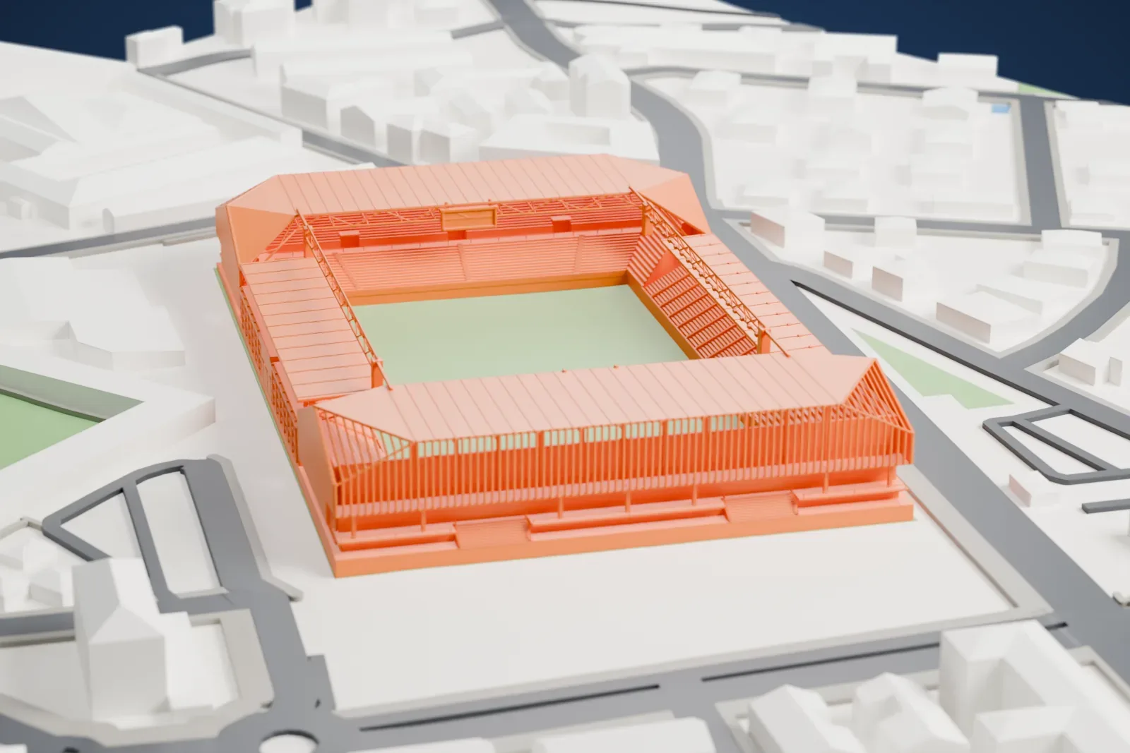 A white 3D print of the Stadio di Bergamo, four covered stands around an open field, among surrounding city buildings.