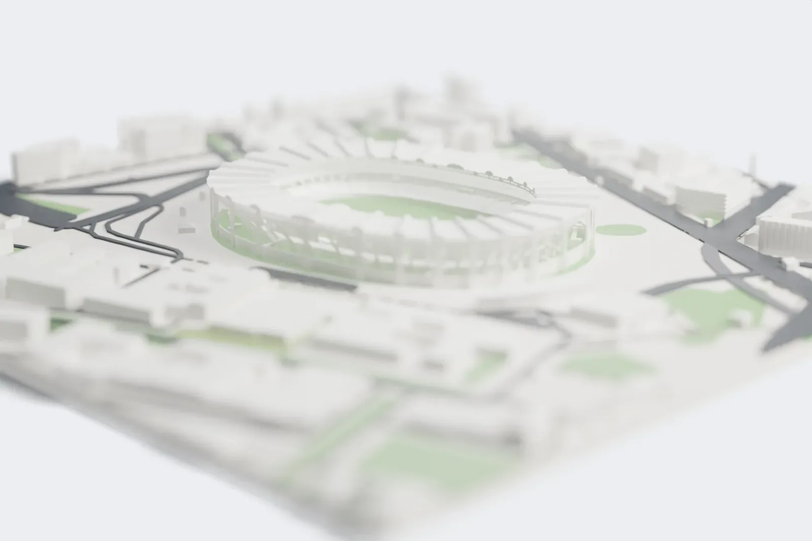 A white 3D print of Stadio Diego Armando Maradona, an oval stadium with a scalloped roof ring held up by slim pylons, surrounded by buildings and open ground.