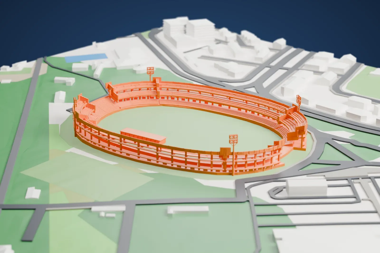 A white 3D print of Stadio Libero Liberati, an oval stadium with stepped stands and floodlight towers around a green pitch, among surrounding streets, buildings and green areas.