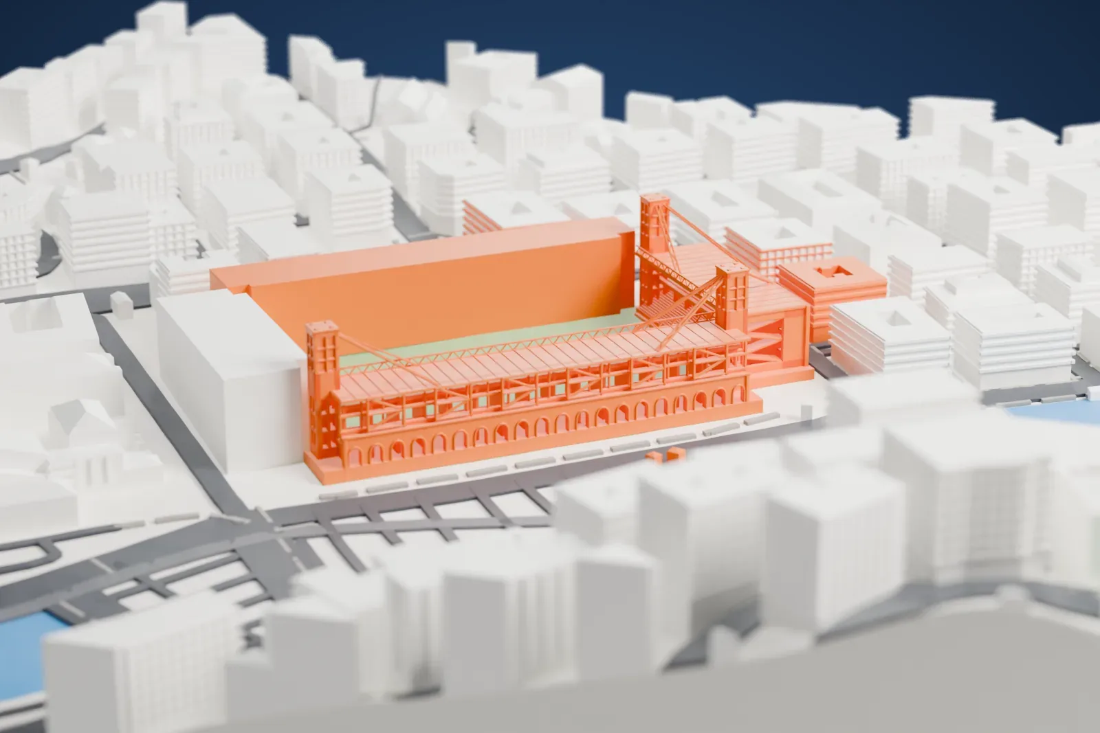 A white 3D print of Stadio Luigi Ferraris, a football stadium with long stands, tall corner towers and diagonal trusses around a green pitch, surrounded by tightly packed buildings and a stretch of water.