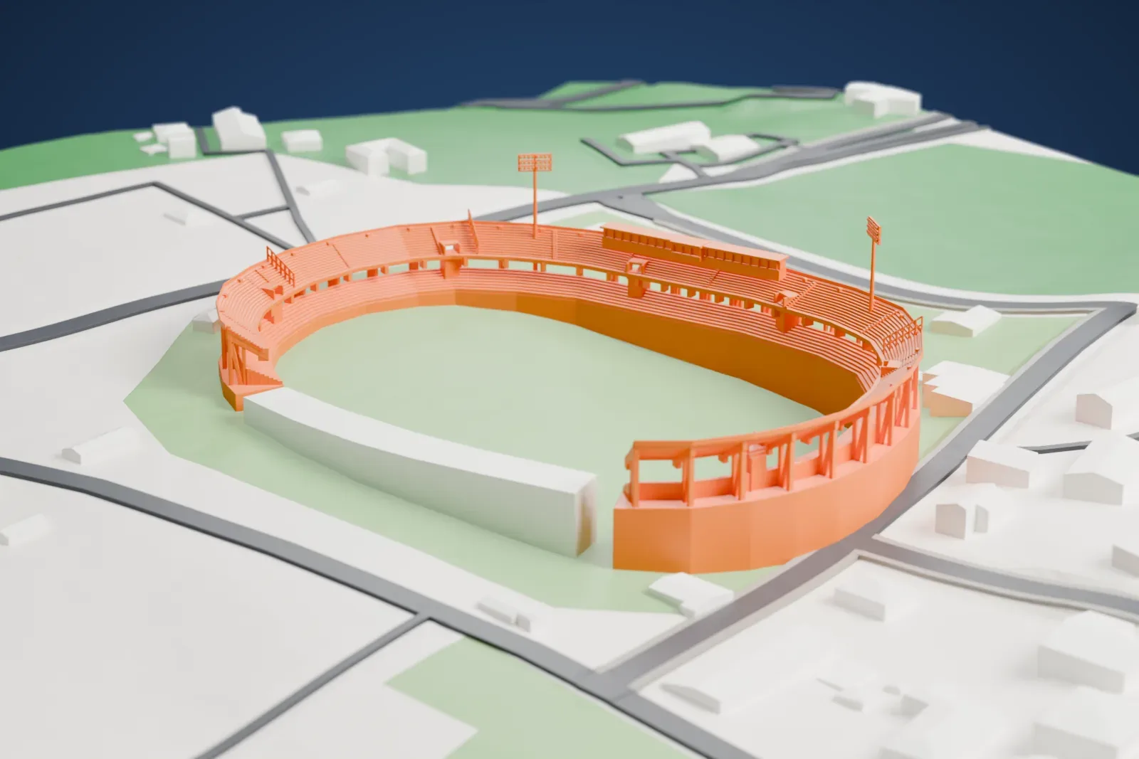 A white 3D print of the Stadio Partenio-Adriano Lombardi, an open three-sided bowl with two seating tiers, a long press cabin and two floodlight masts, among the surrounding streets and buildings of Avellino.