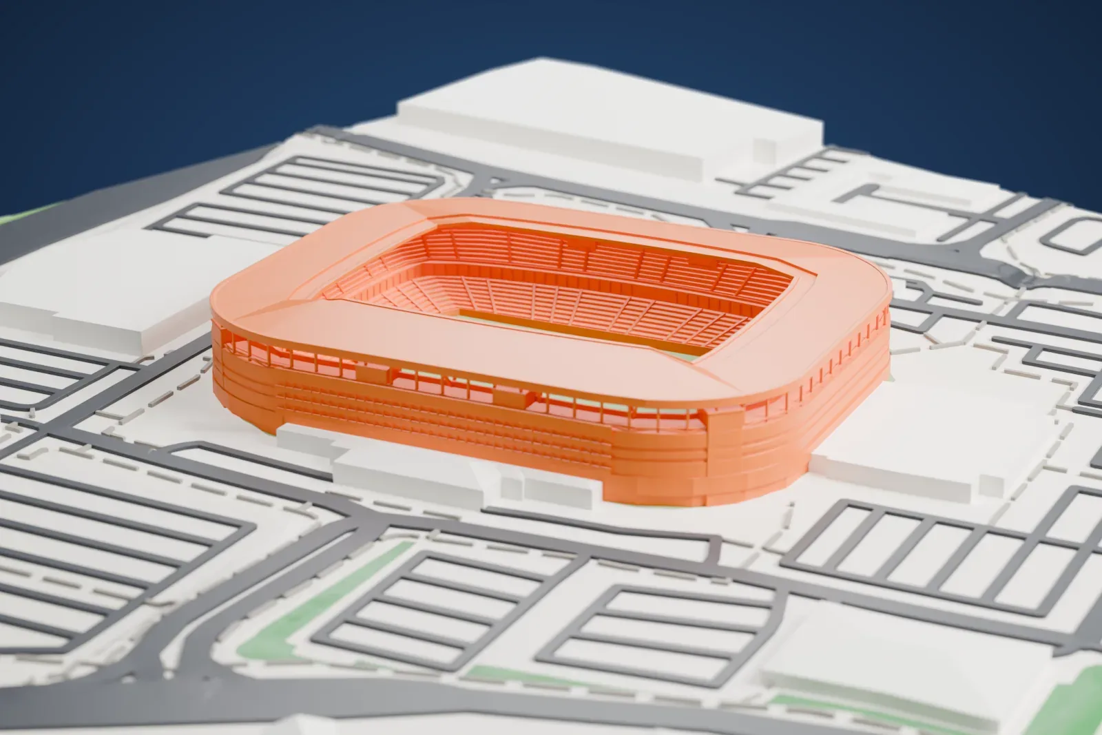 A white 3D print of Stadium MK, a rounded rectangular bowl under one continuous roof that steps down over the ends, with an open steel storey under the roof edge, among the surrounding streets and buildings.