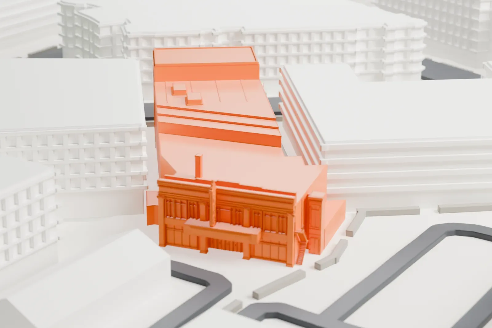 A white 3D print of the State Theatre in New Brunswick, a long narrow building with a decorated front at one end, squeezed between larger buildings.
