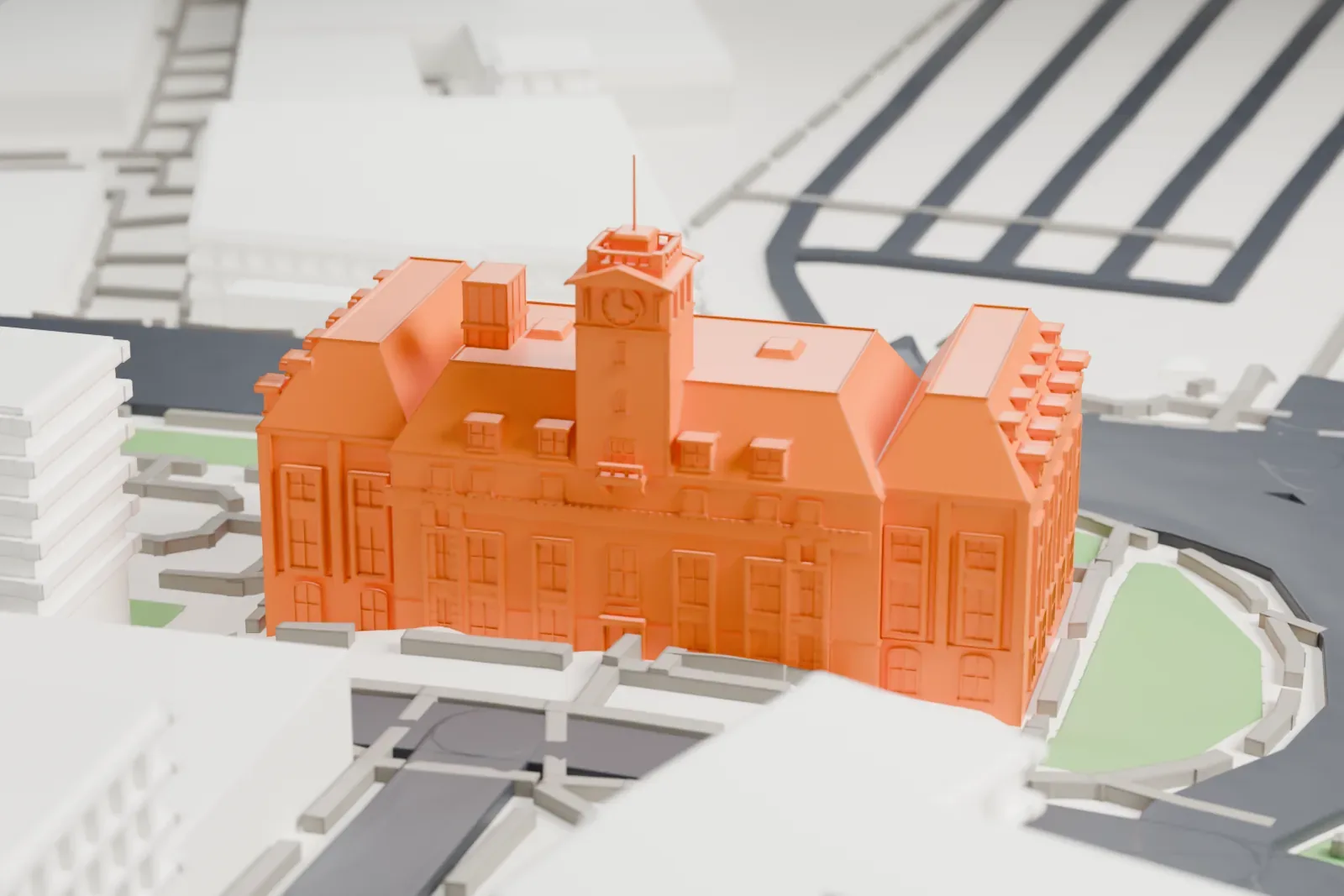 A white 3D print of Staten Island Borough Hall, a building with steep roofs, rows of dormers and a clock tower, set among curving roads and small green spaces.