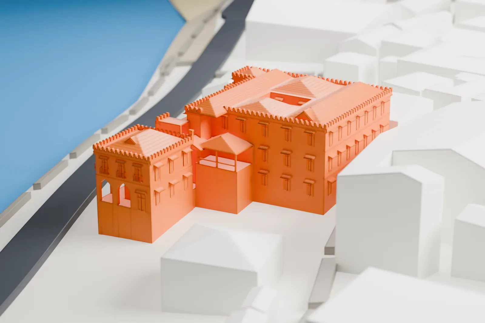 A white 3D print of the Sultan's Palace, Zanzibar, with decorated roof edges and an arched balcony facade beside a waterfront road and closely spaced buildings.