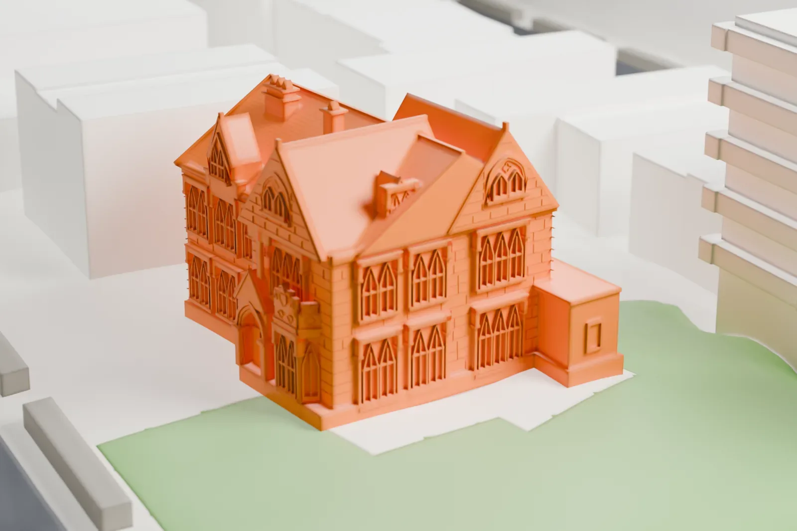 A white 3D print of Sunnyslope, a steep-gabled house with several wings and a green yard, surrounded by taller buildings and streets.