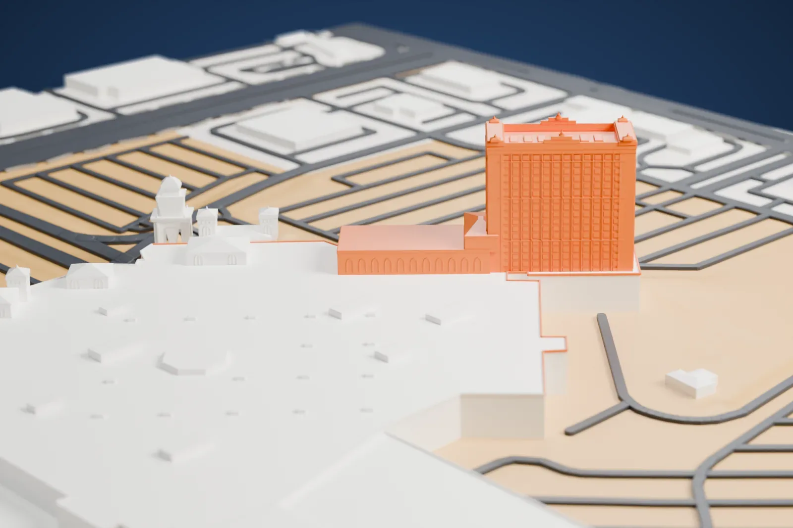 A white 3D print of Sunset Station, a wide, low casino building with small domed turrets and a taller hotel tower at one end, surrounded by parking lots and roads.