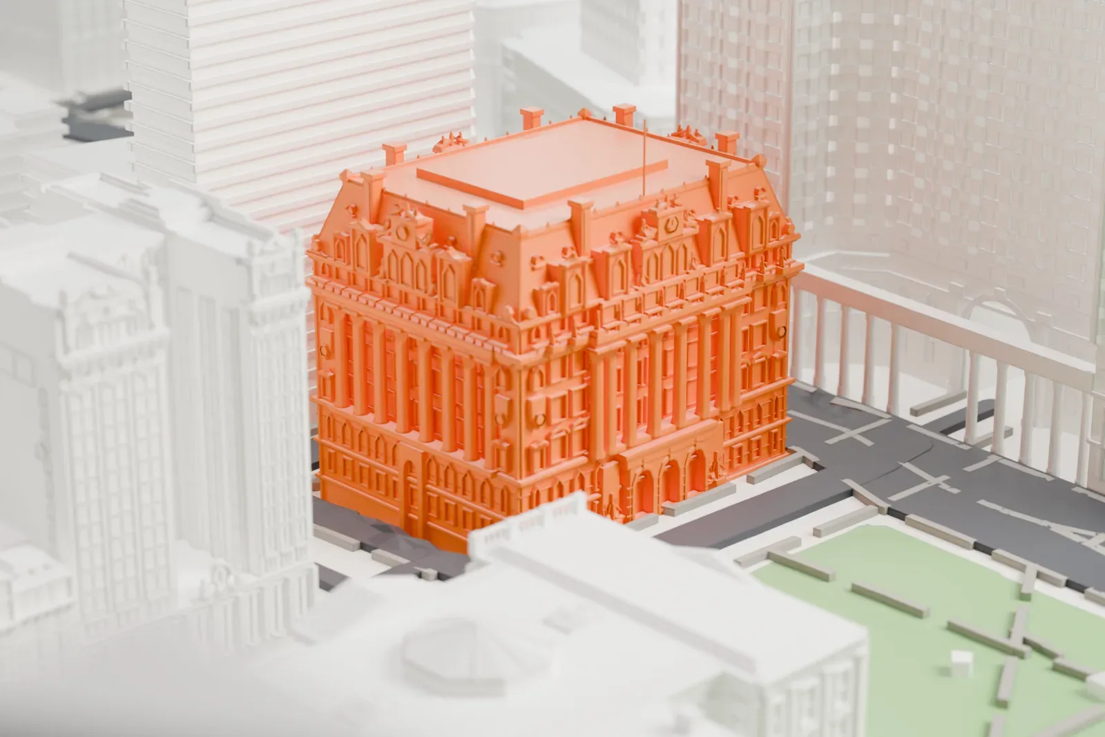 A white 3D print of the Surrogate's Courthouse, an ornate masonry building with a steep roofline, beside a park and tall neighboring buildings.