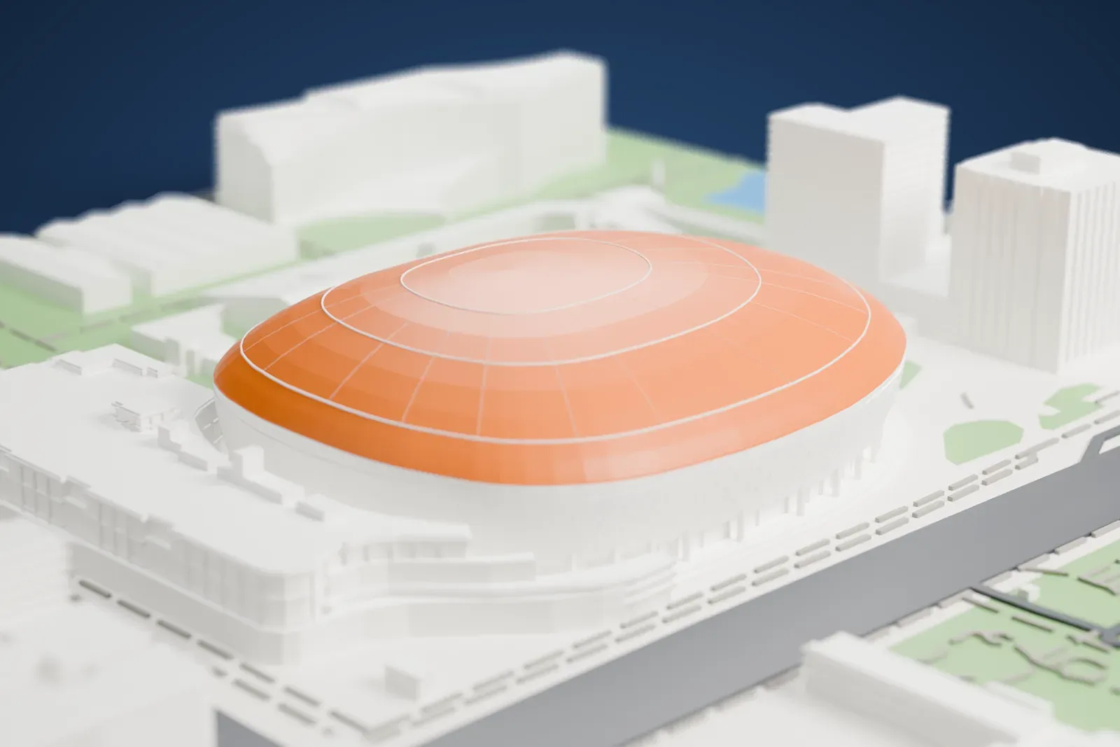 A white 3D print of Taipei Dome, a wide, low dome with a ribbed roof and a ring of columns at its base, among buildings, green park areas and wide roads.