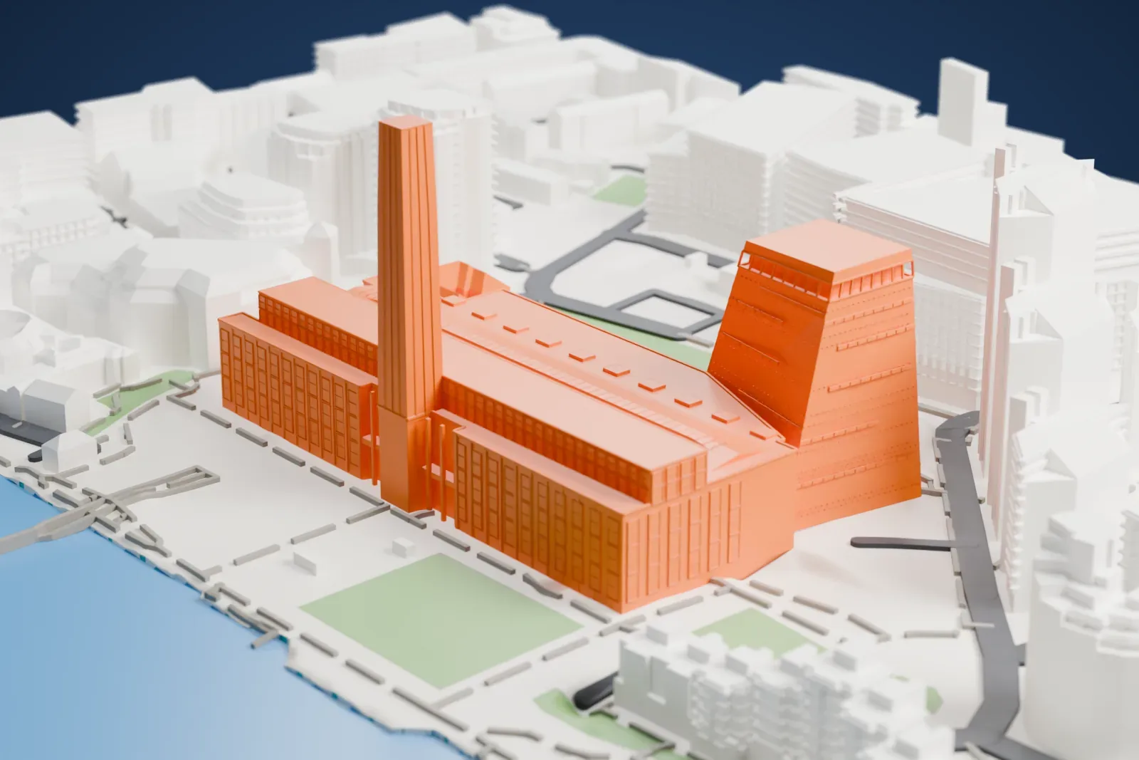 A white 3D print of Tate Modern, a long building with a tall square chimney and a tapering tower beside it, among taller buildings and green squares with the river along one side.