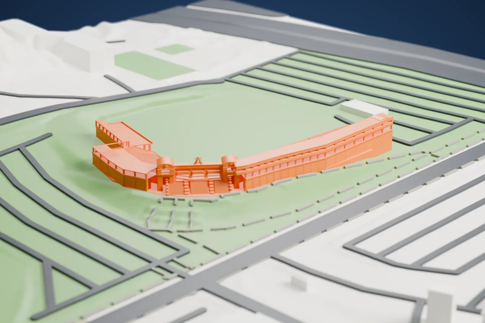 A white 3D print of Tempe Diablo Stadium, a curved grandstand with tiered seating wrapping a corner of a green field, with parking rows and roads around it.