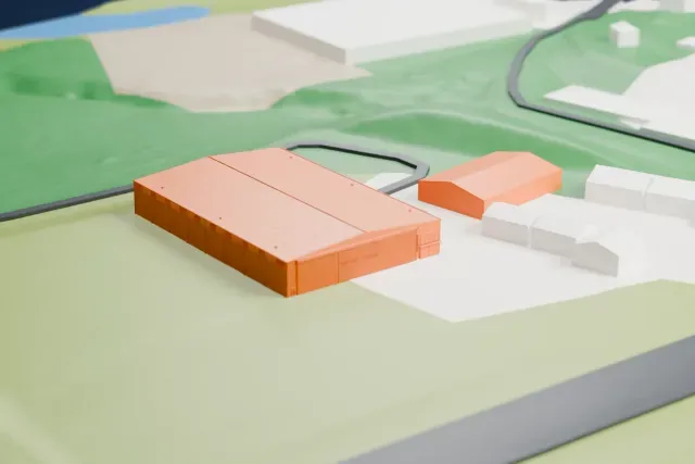A white 3D print of the Tennessee Museum of Aviation Hangar model in Knoxville, with the streets around it.