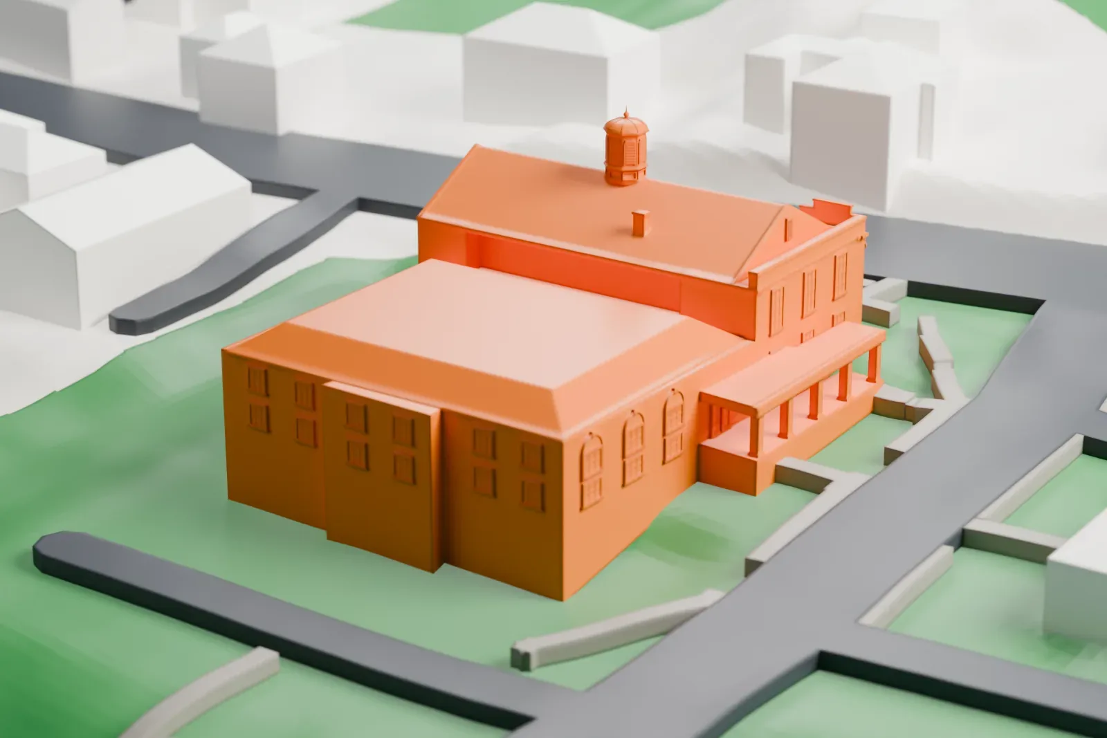 A white 3D print of The Bryant Library, a small building beside a road, with a pond, park meadow and wooded hillsides around it.