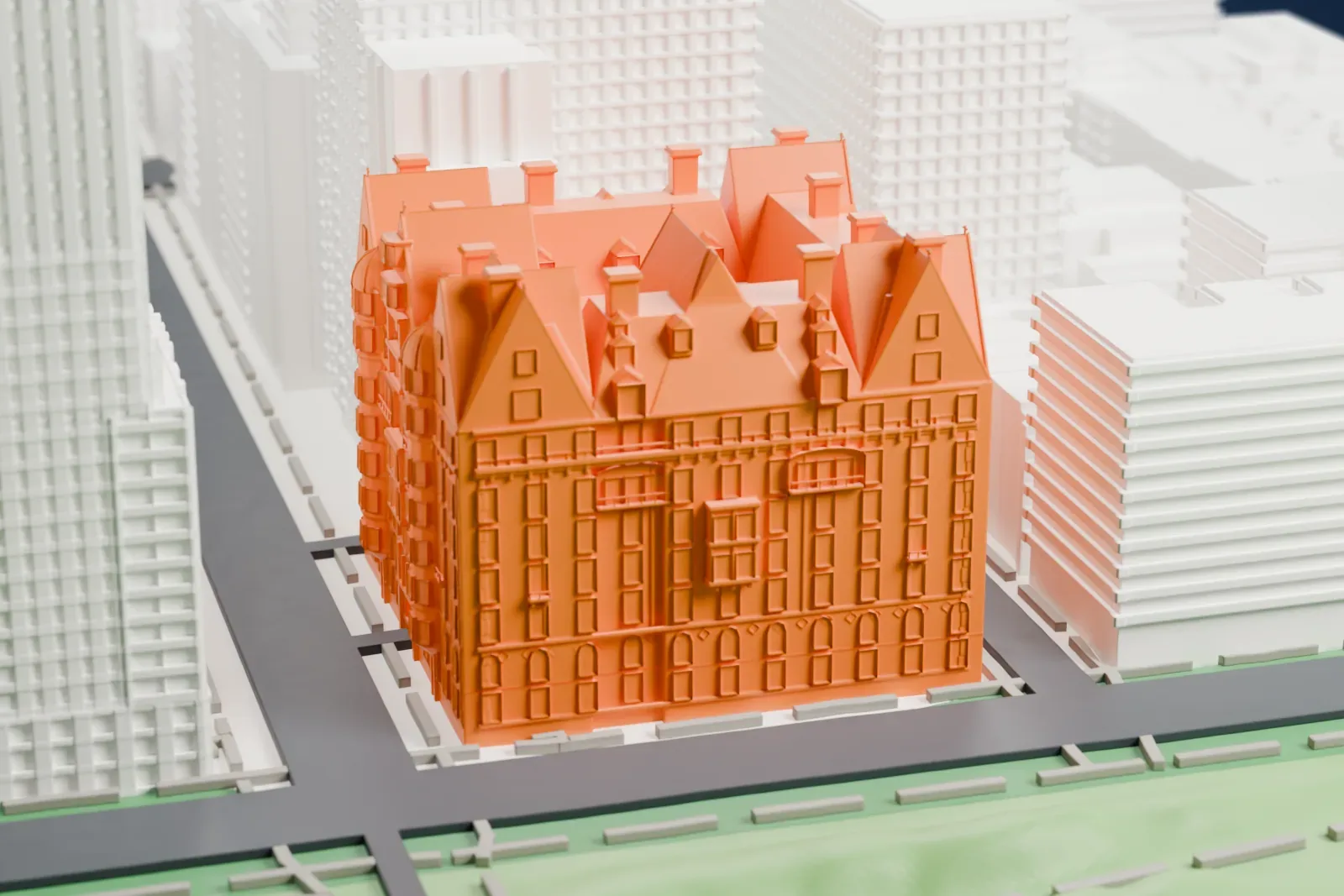 A white 3D print of The Dakota, a large building with steep gabled roofs and dormers, beside a park and surrounded by taller city buildings.