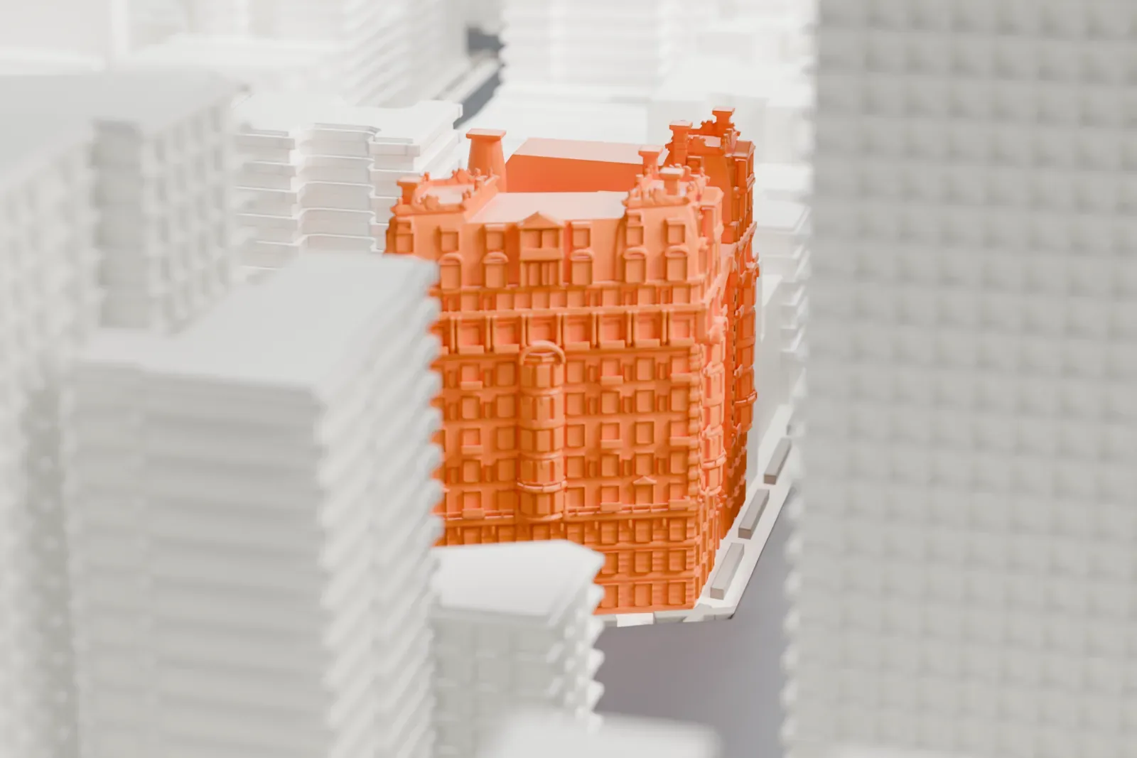 A white 3D print of the Dorilton, an ornate brick-and-stone building with a steep mansard roof and dormers on a street corner, beside much taller buildings.