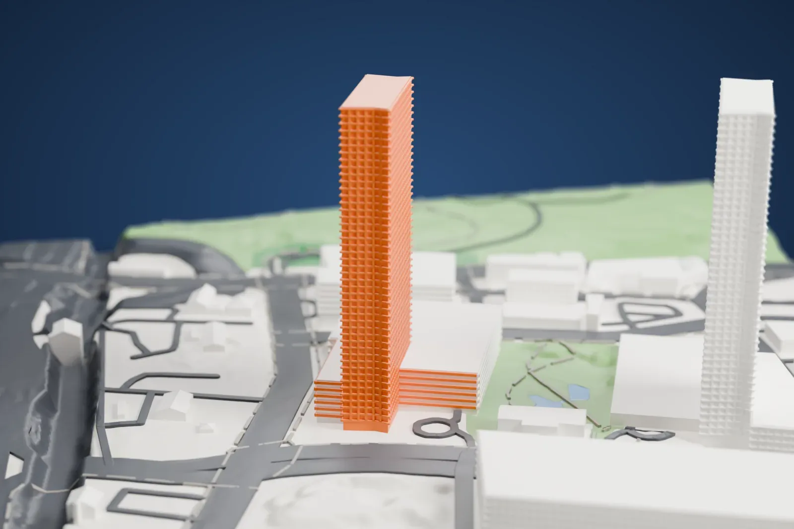 A white 3D print of The Modern, a tall slim tower on a wide podium, beside roads, a small park and a second tower.