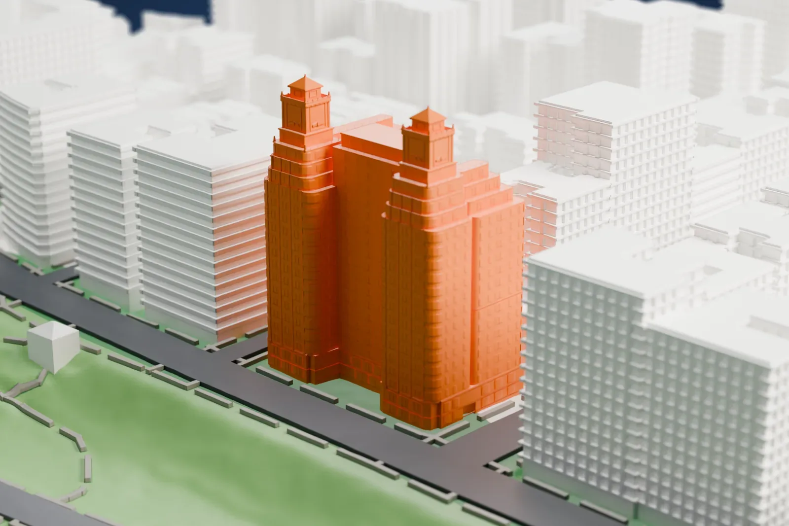 A white 3D print of the Normandy, a tall H-shaped apartment building with stepped setbacks and two small towers, beside a riverside road and a park with other buildings around it.