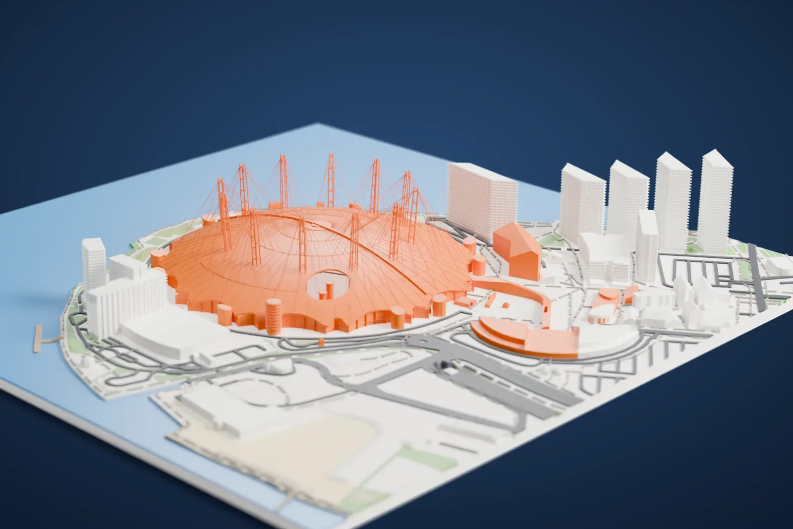 A white 3D print of The O2 Arena, a wide dome ringed by tall masts with cables fanning across it, on a peninsula surrounded by water with buildings and roads beside it.