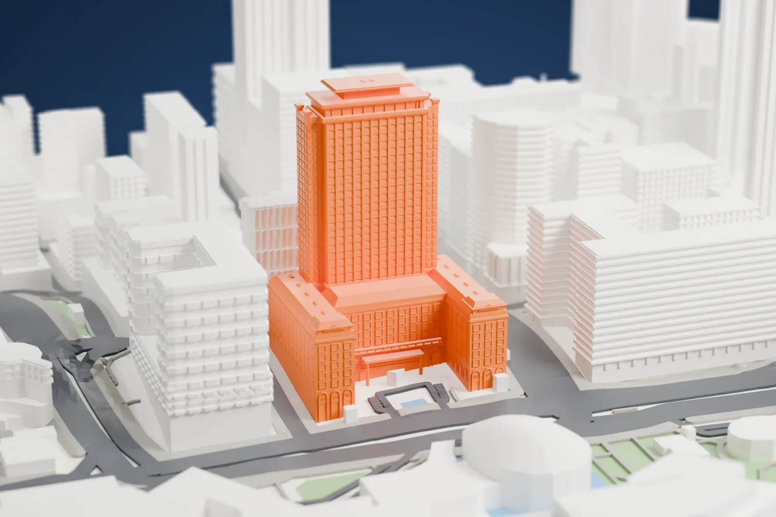 A white 3D print of The Peninsula Hong Kong, with the surrounding streets and buildings around it.