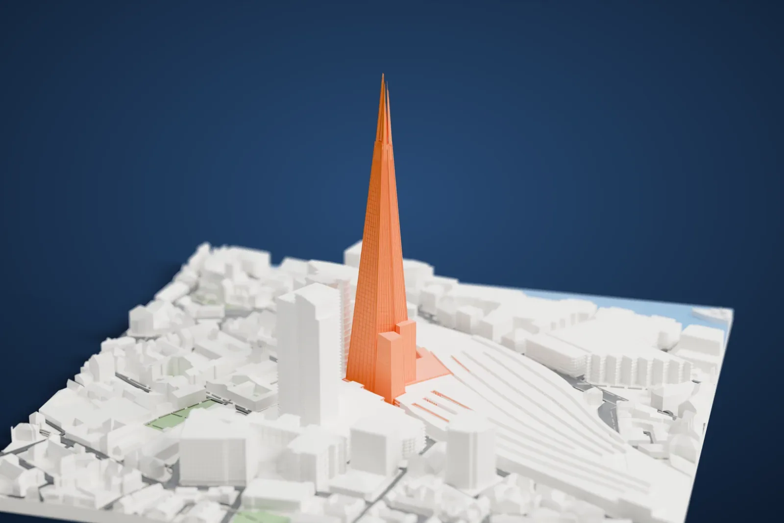 A white 3D print of The Shard, a very tall glass pyramid narrowing to a split, spire-like tip, rising above railway tracks and city blocks.
