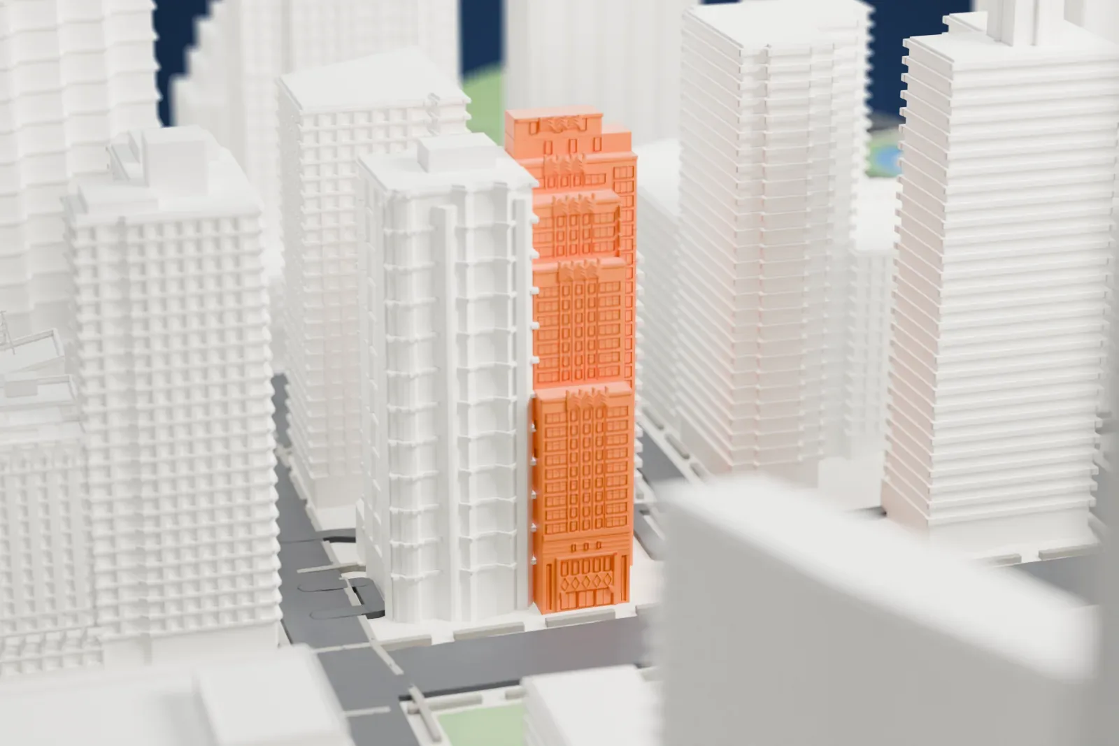 A white 3D print of The Sofia, a tall stepped tower with narrow setbacks near the top, standing among other tall buildings.